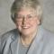 smiling woman in gray suit