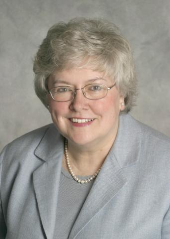 a woman in a suit smiling