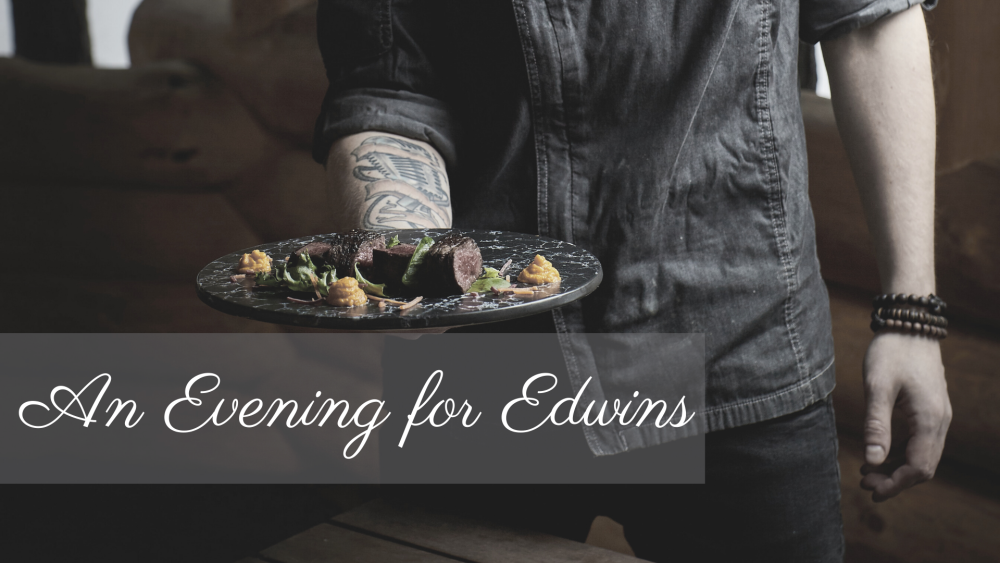 man with tattoos on arm presenting plate of food