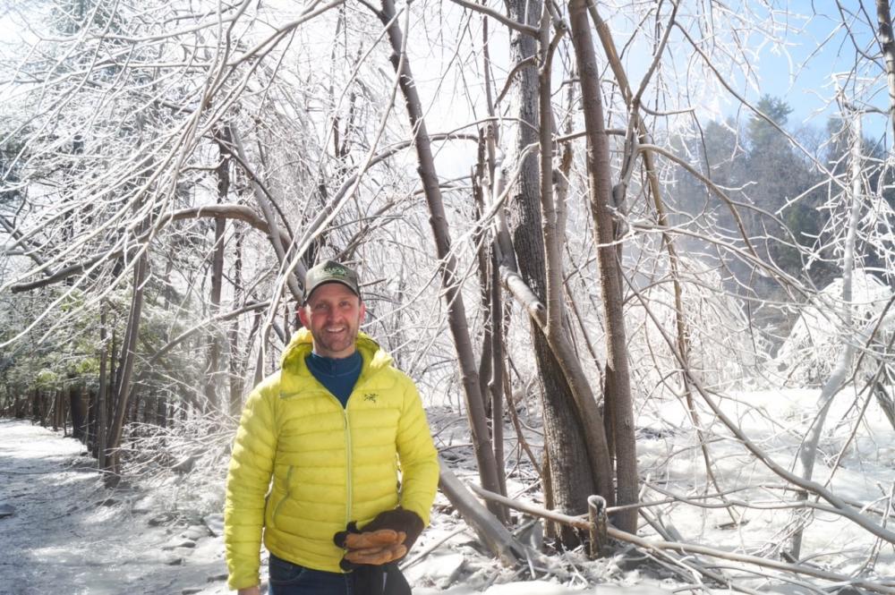 man in a yellow parka against a snowy landscape