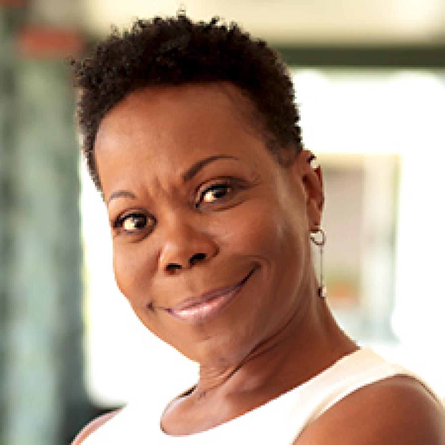 A picture of panelist, Karen Clark smiling. She's wearing a white shirt.