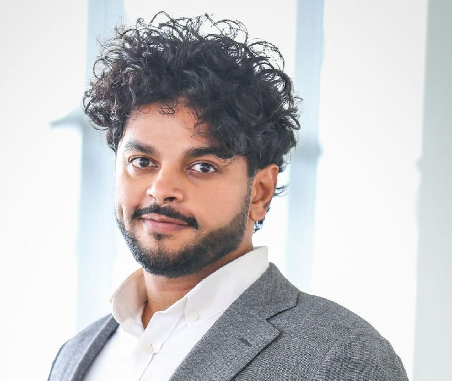 Ashok Sivanand Headshot, man w/dark beard & dark curly hair
