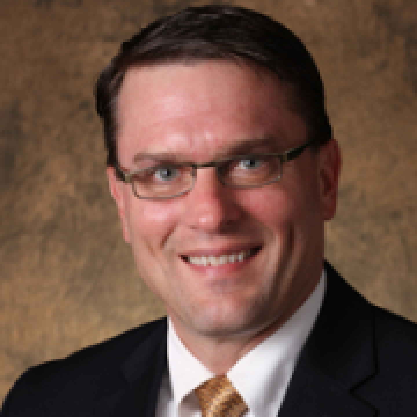 smiling man in suit with glasses