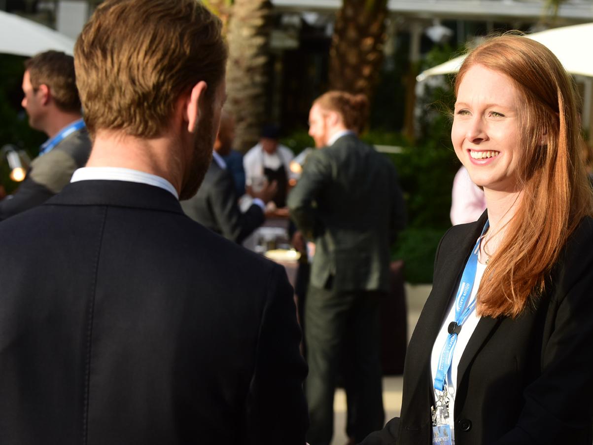 Two ACG colleagues meeting at an outdoor event