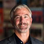 Smiling man with salt-and-pepper goatee