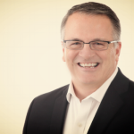 smiling man with glasses